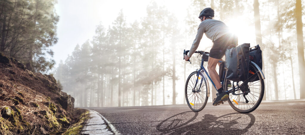 man cycling through wood