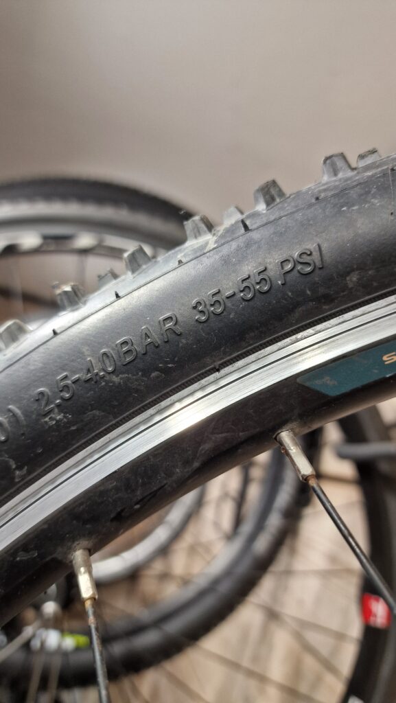 Example of recommended tyre pressure embossed on the side of a bicycle tyre